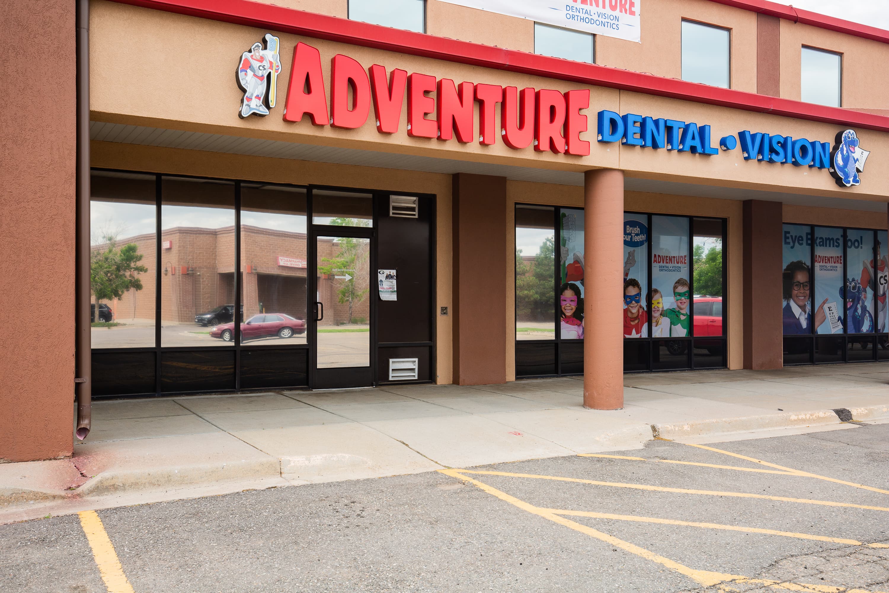 exterior of building with a sign that says Adventure Dental and Vision