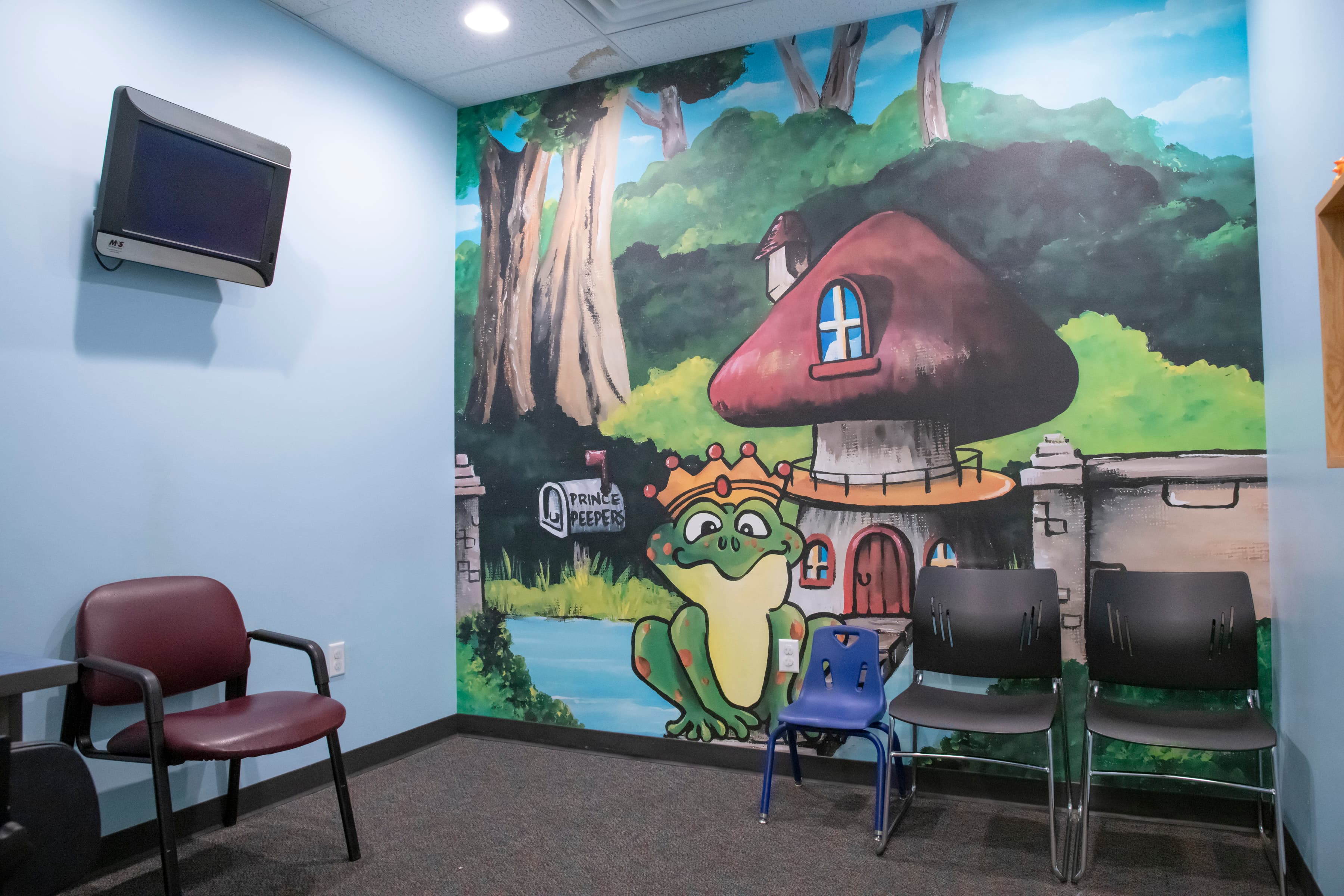 dental waiting room with a frog image painted on a wall