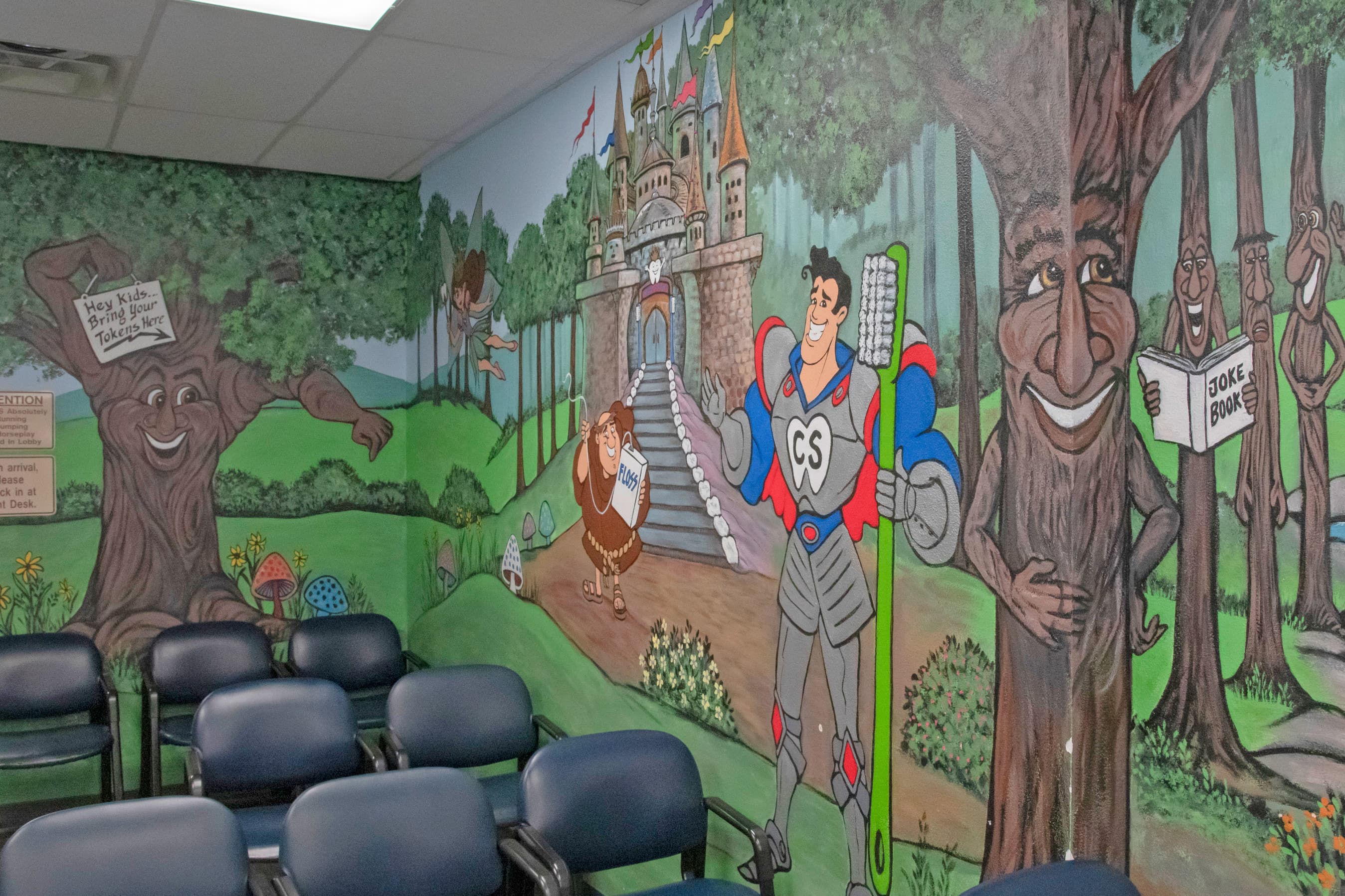 waiting room with a large mural painted on the wall