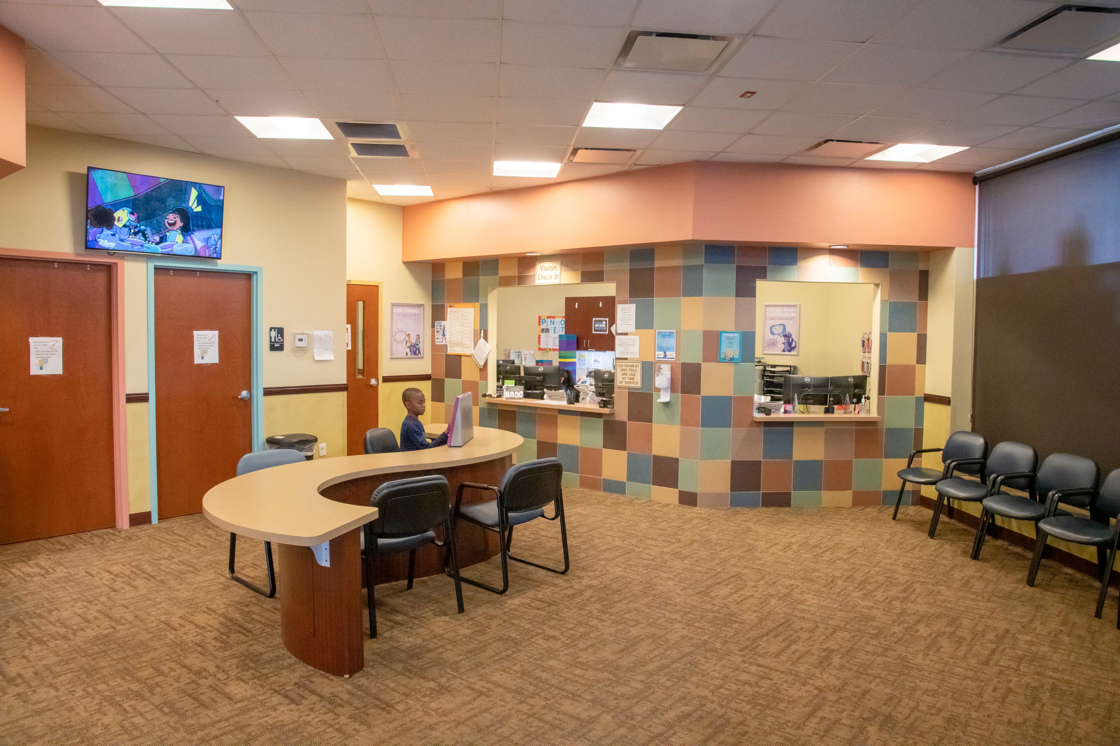 waiting room at children's dentist office with wood counters and blue chairs