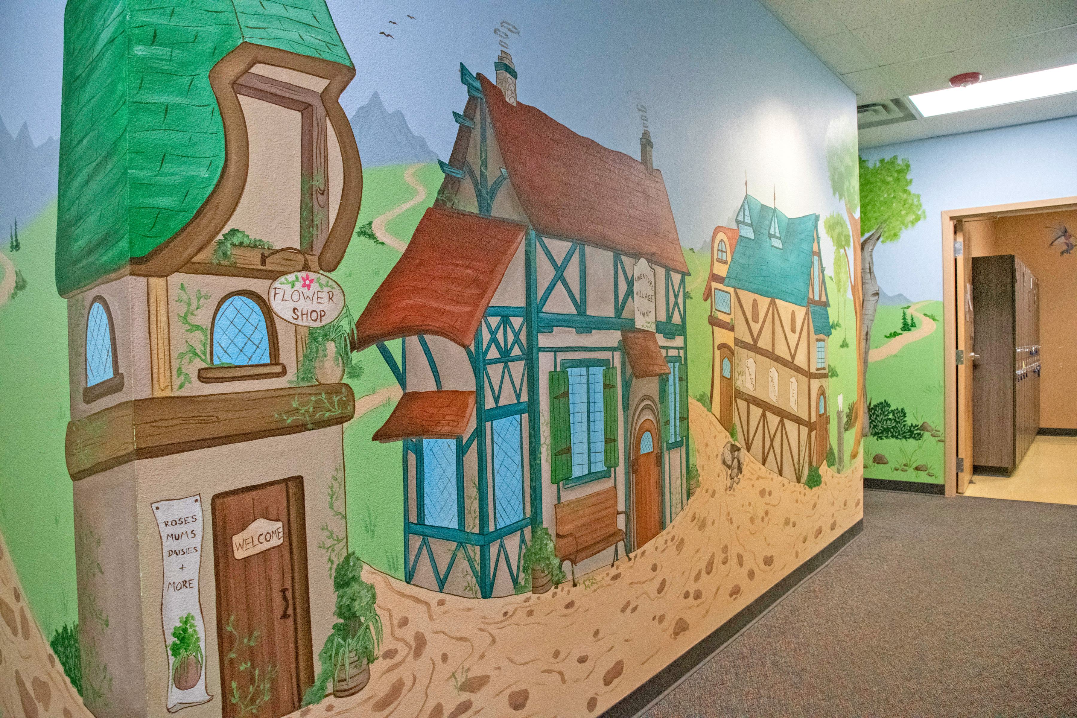mural on wall with two cottage homes