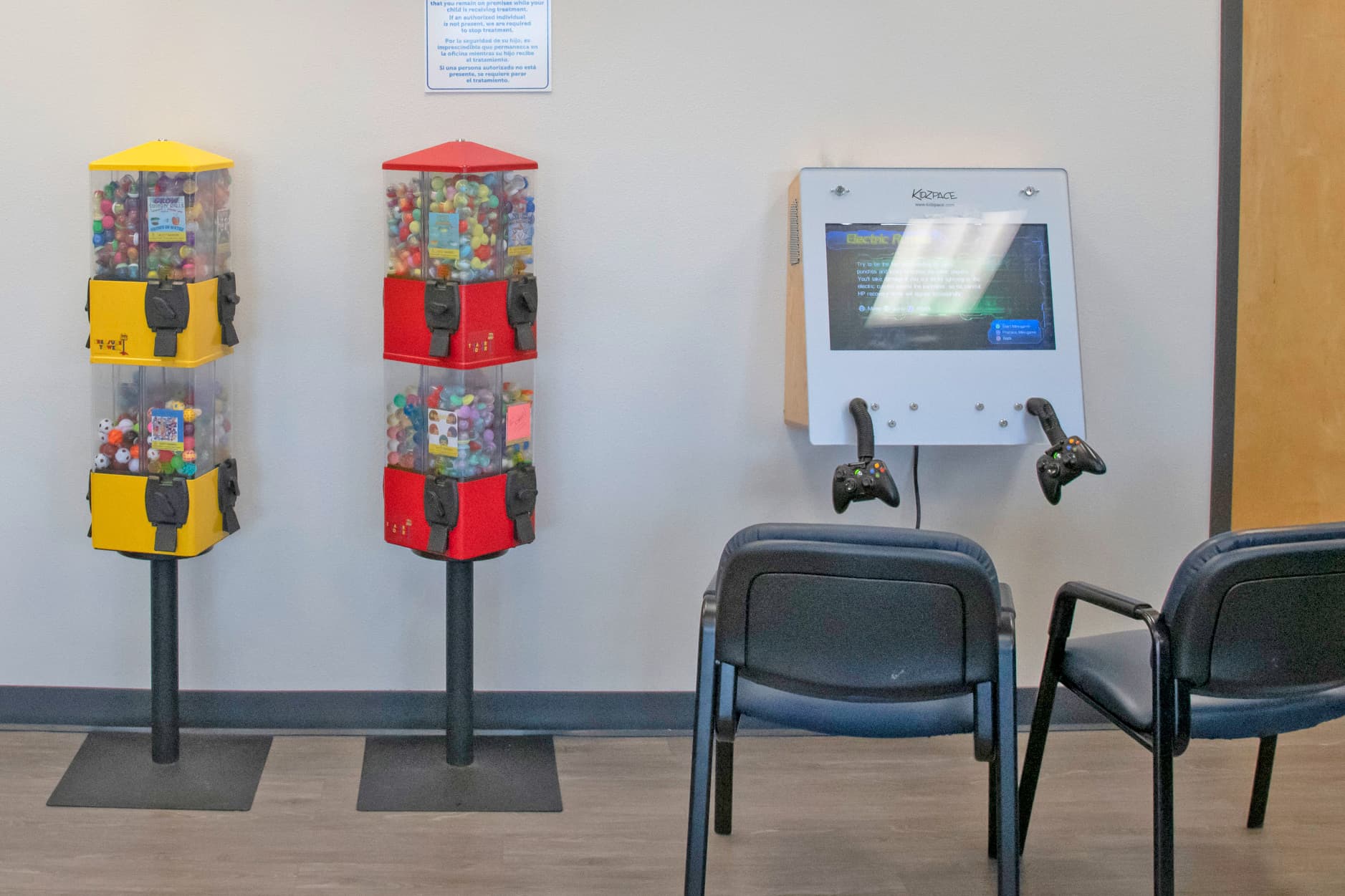 kid's dental office with video games and a red and yellow vending machines