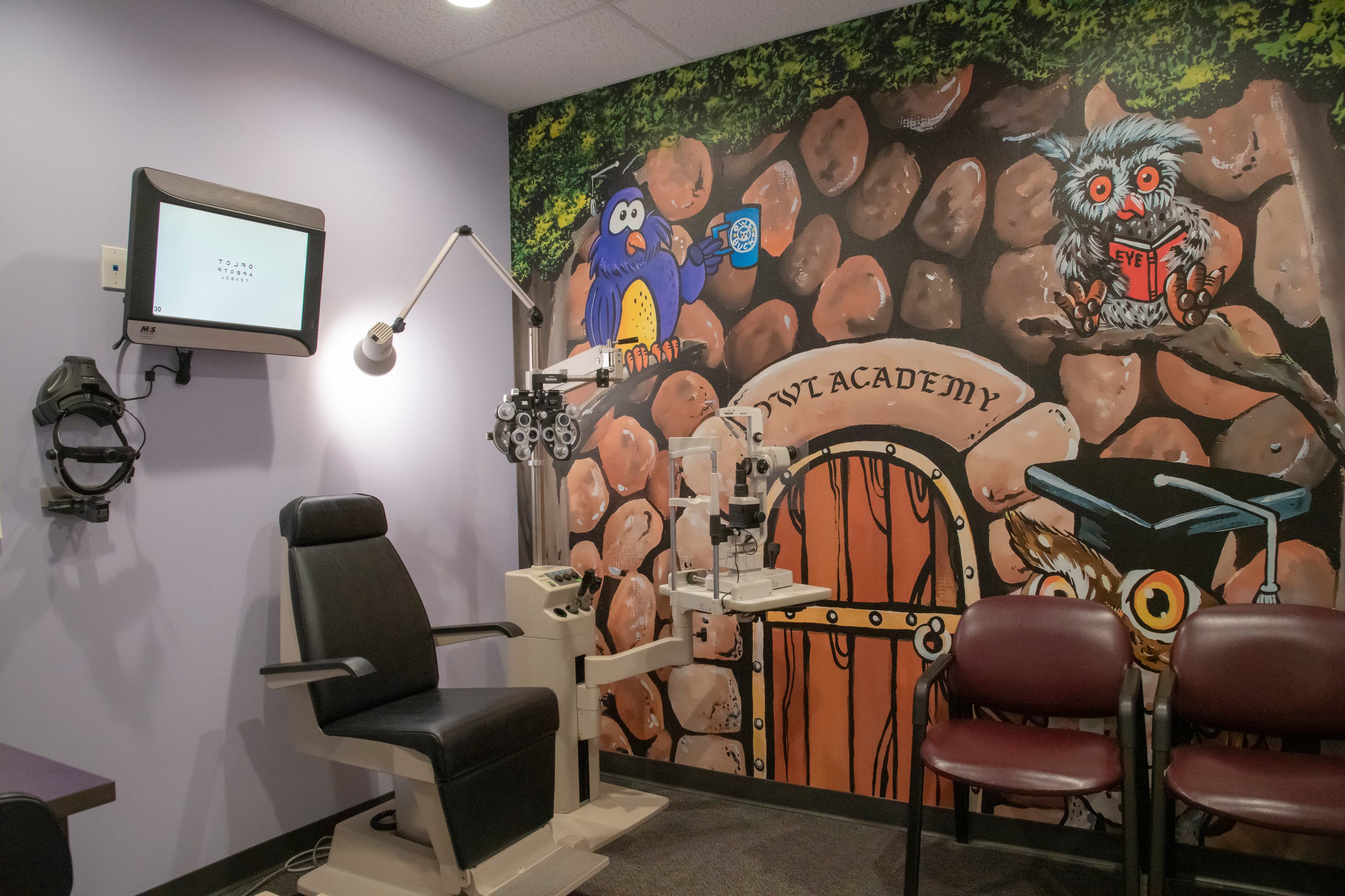 Dental and orthodontics exam office with colorful mural and three chairs