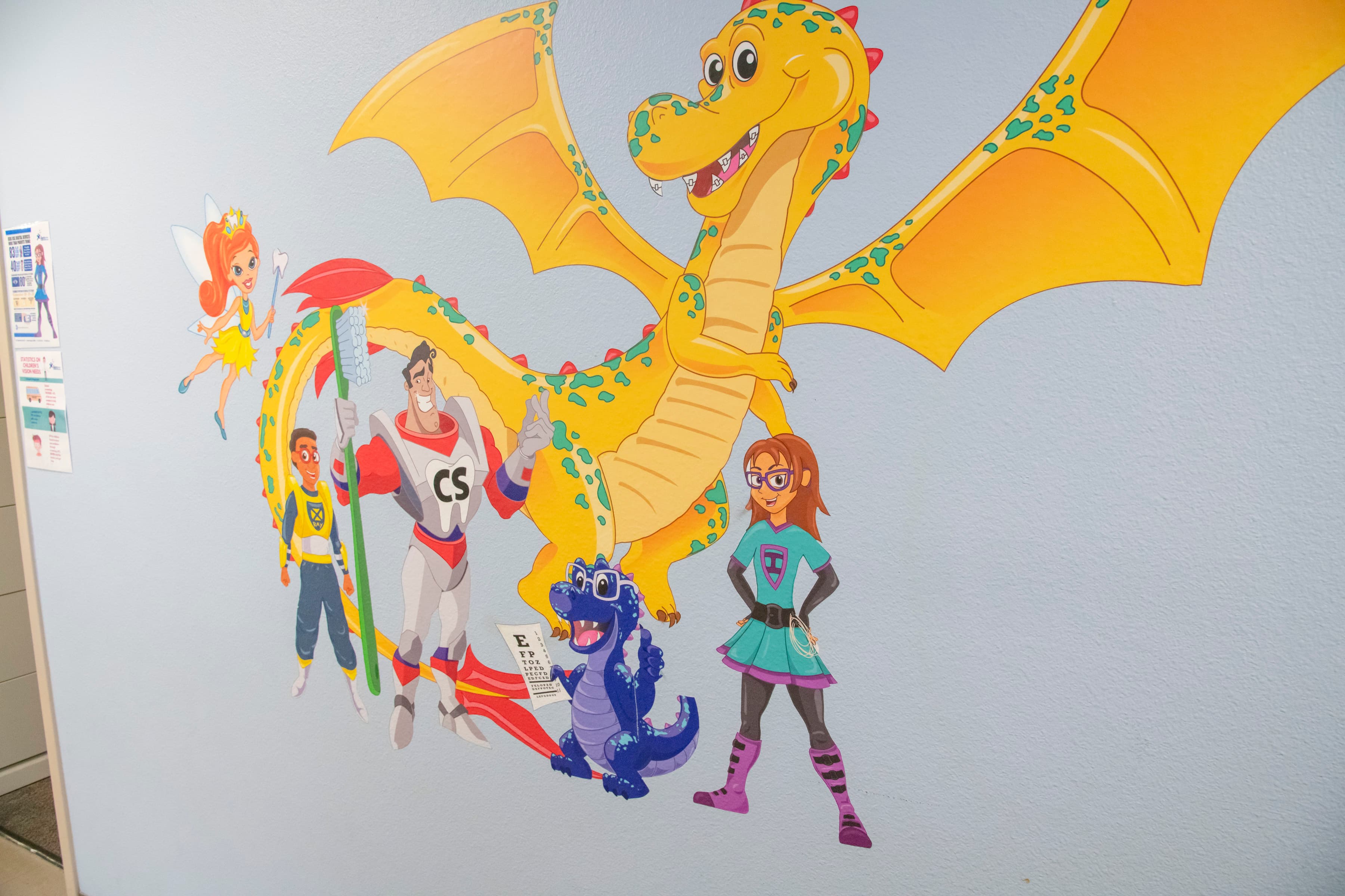 wall graphic with a huge yellow dragon and four cartoon characters