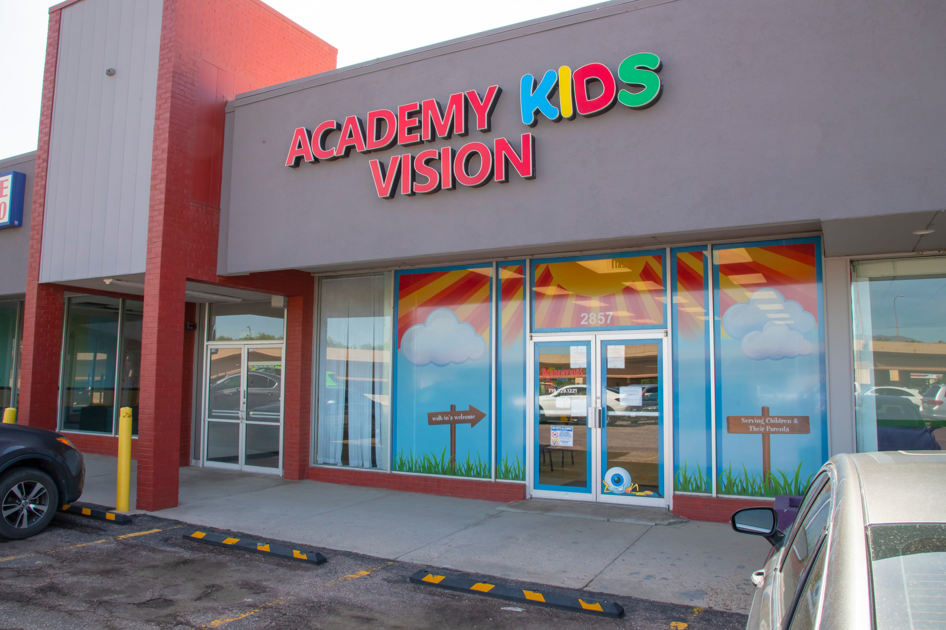 A colorful sign outside of a building in Colorado Springs that says Academy Kids Vision