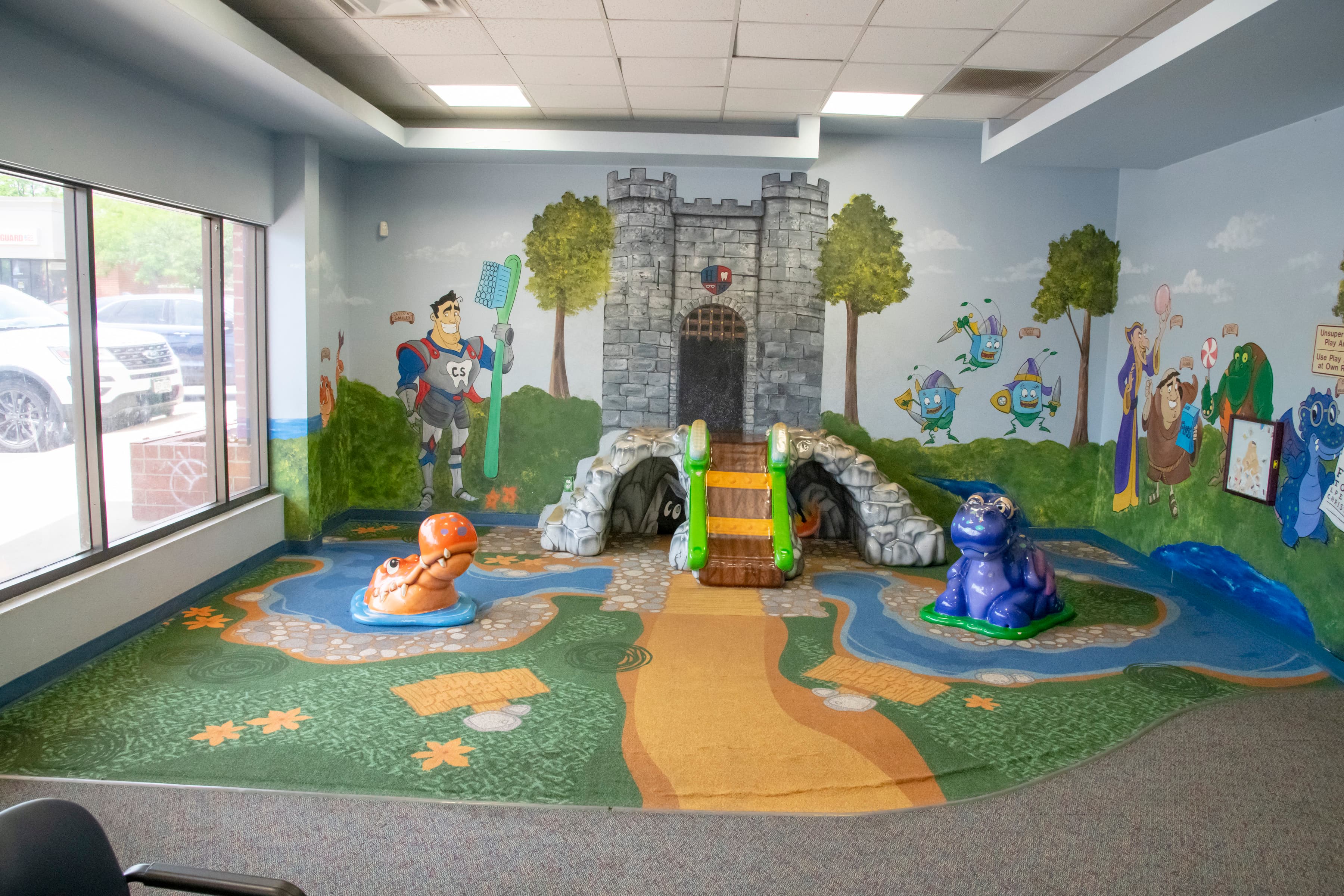 playroom for children with a slide and cartoon characters