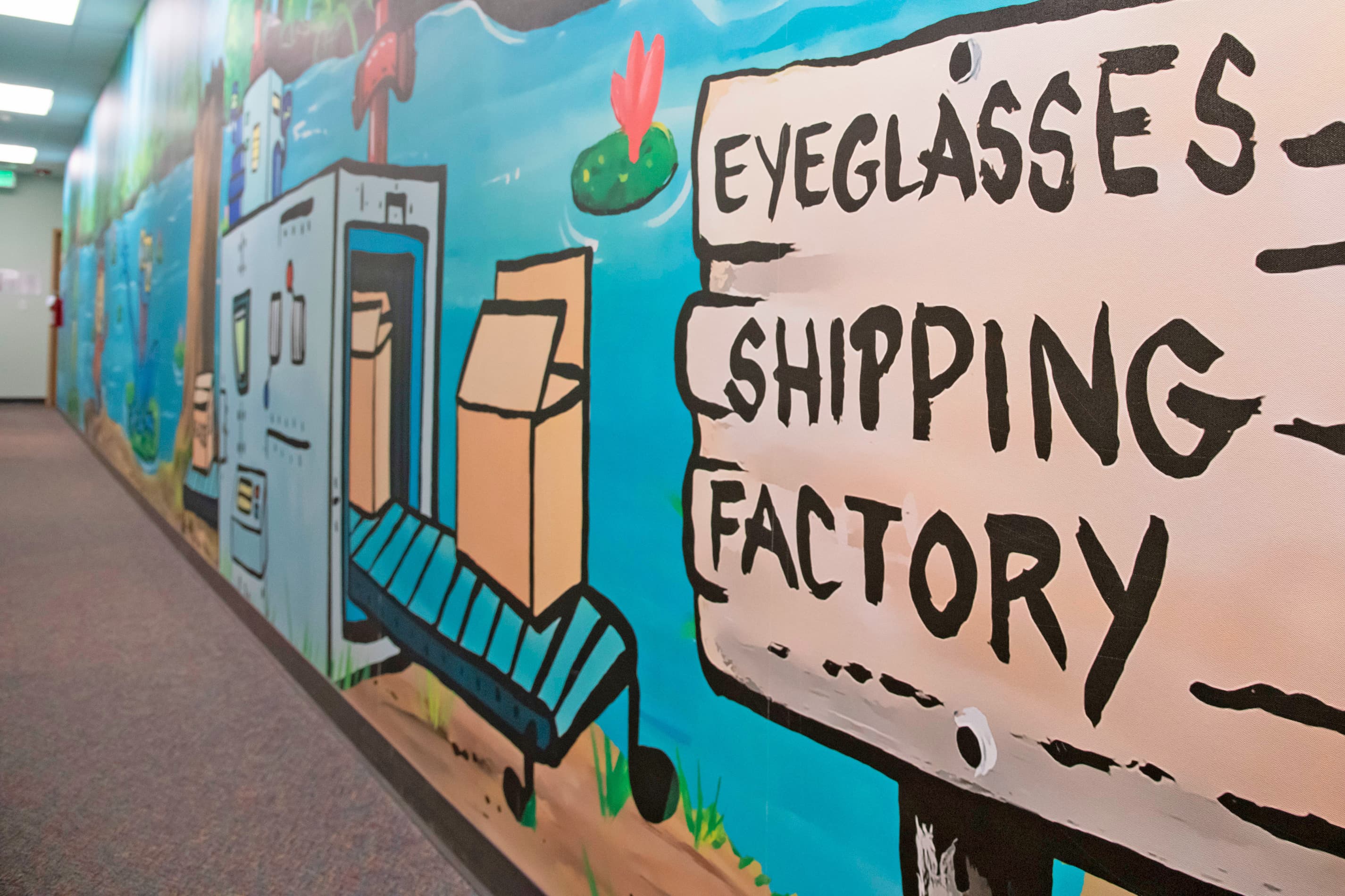 hallway mural with painted sign that says eyeglass shipping factory