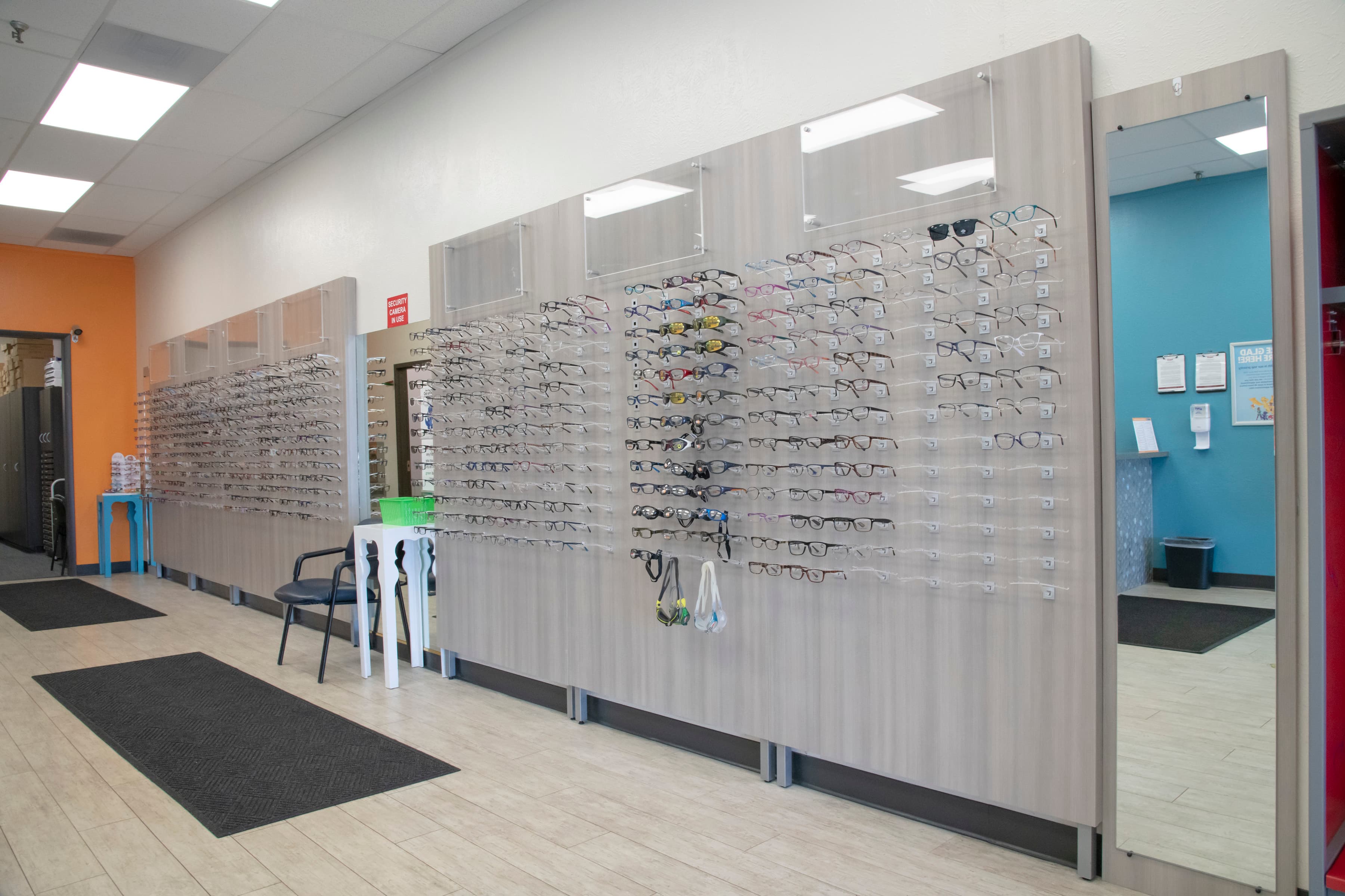 two walls displaying hundreds of children's glasses