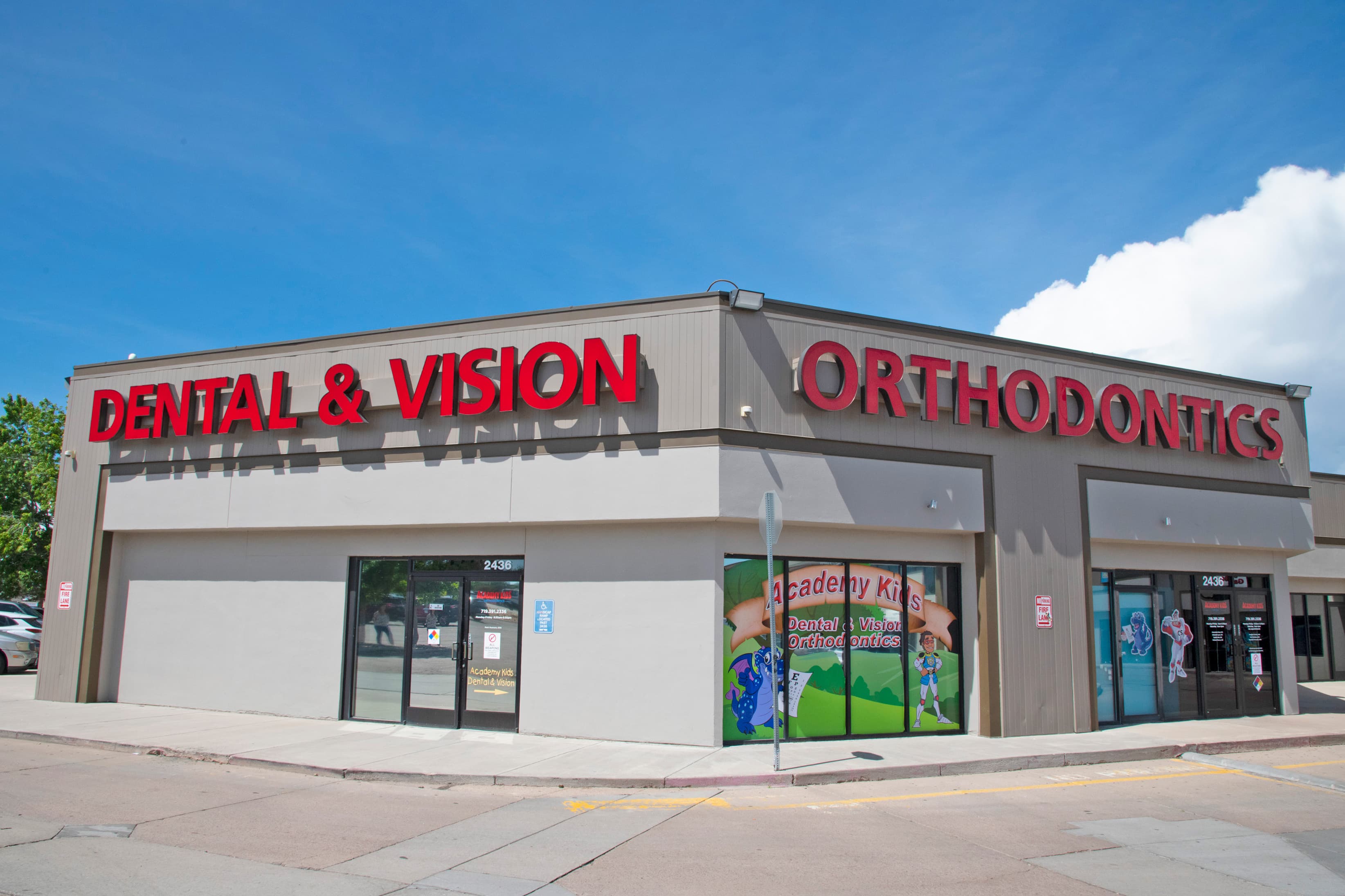 building exterior with with a sign that says dental, vision and orthodontics in red letters