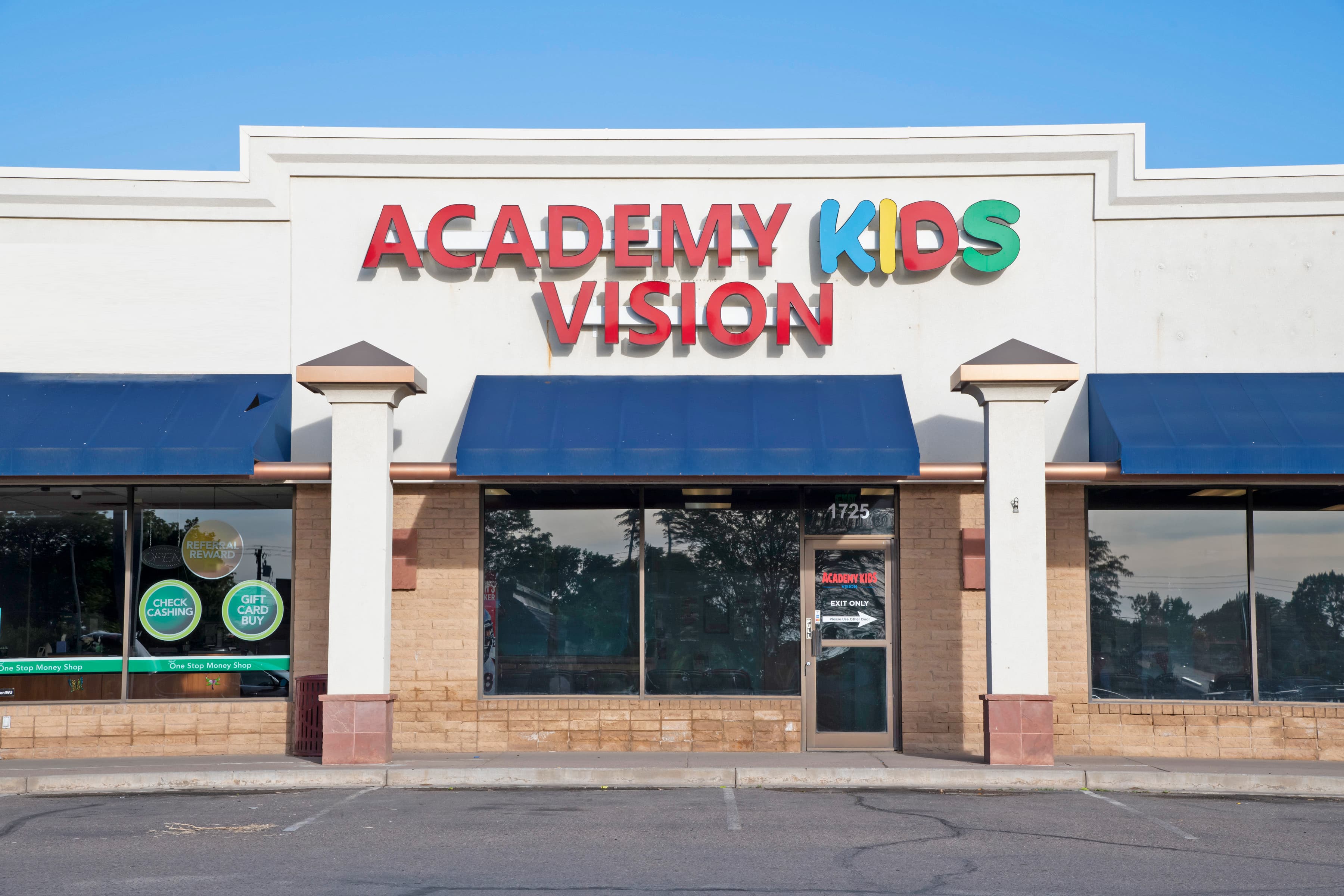 exterior of building that has a colorful sign that says Academy Kids Vision