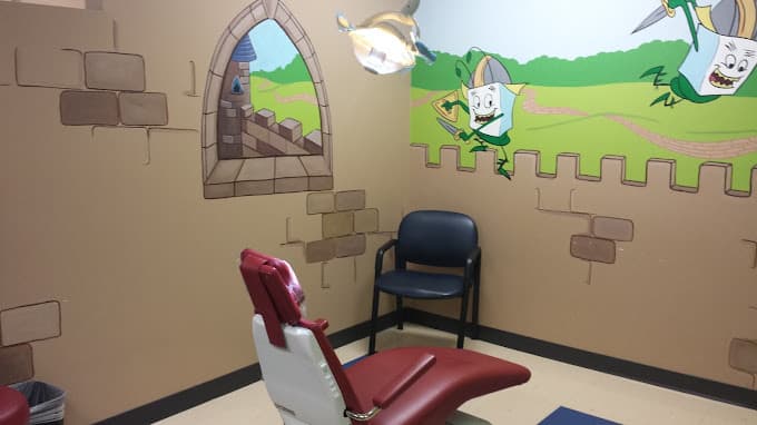Pediatric dental exam room with colorful wall mural