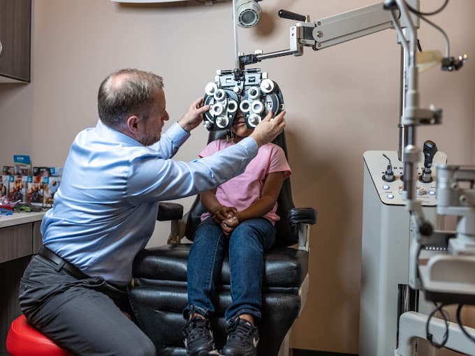 Optometrist  providing child a vision exam