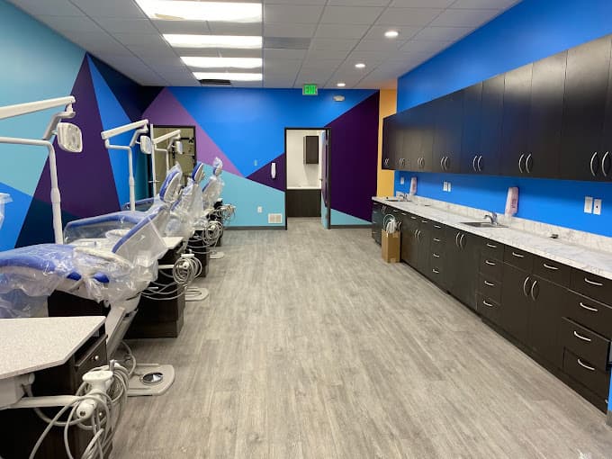 Dental and orthodontics operatory with multiple dental chairs, multi colored blue walls
