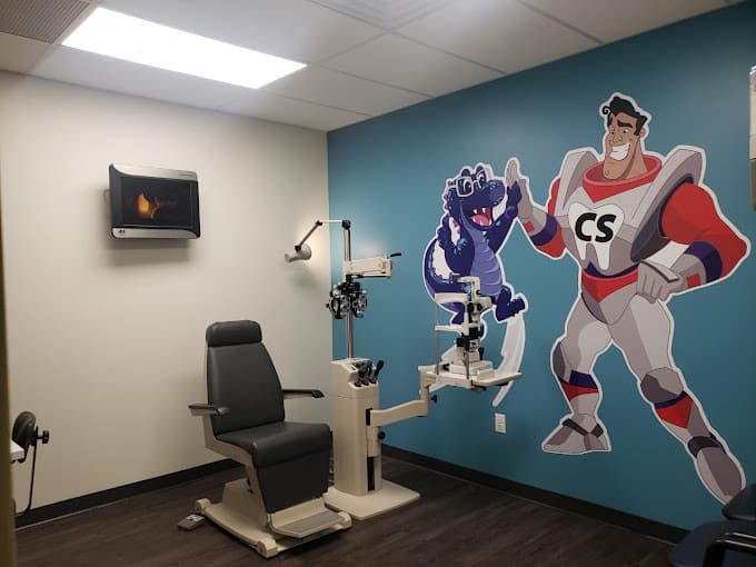 pediatric optometrist exam room with Captain Smile and Specs mural on the wall