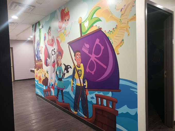 colorful mural in a hallway depicting Captain Smiles on the deck of a ship