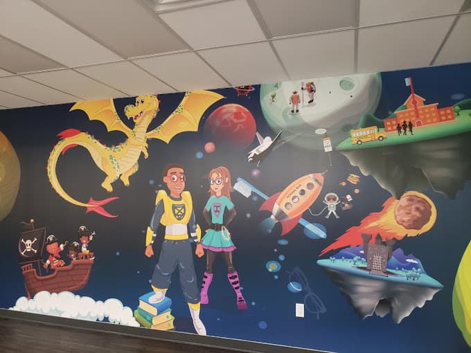 large colorful wall mural with cartoon characters in space scene