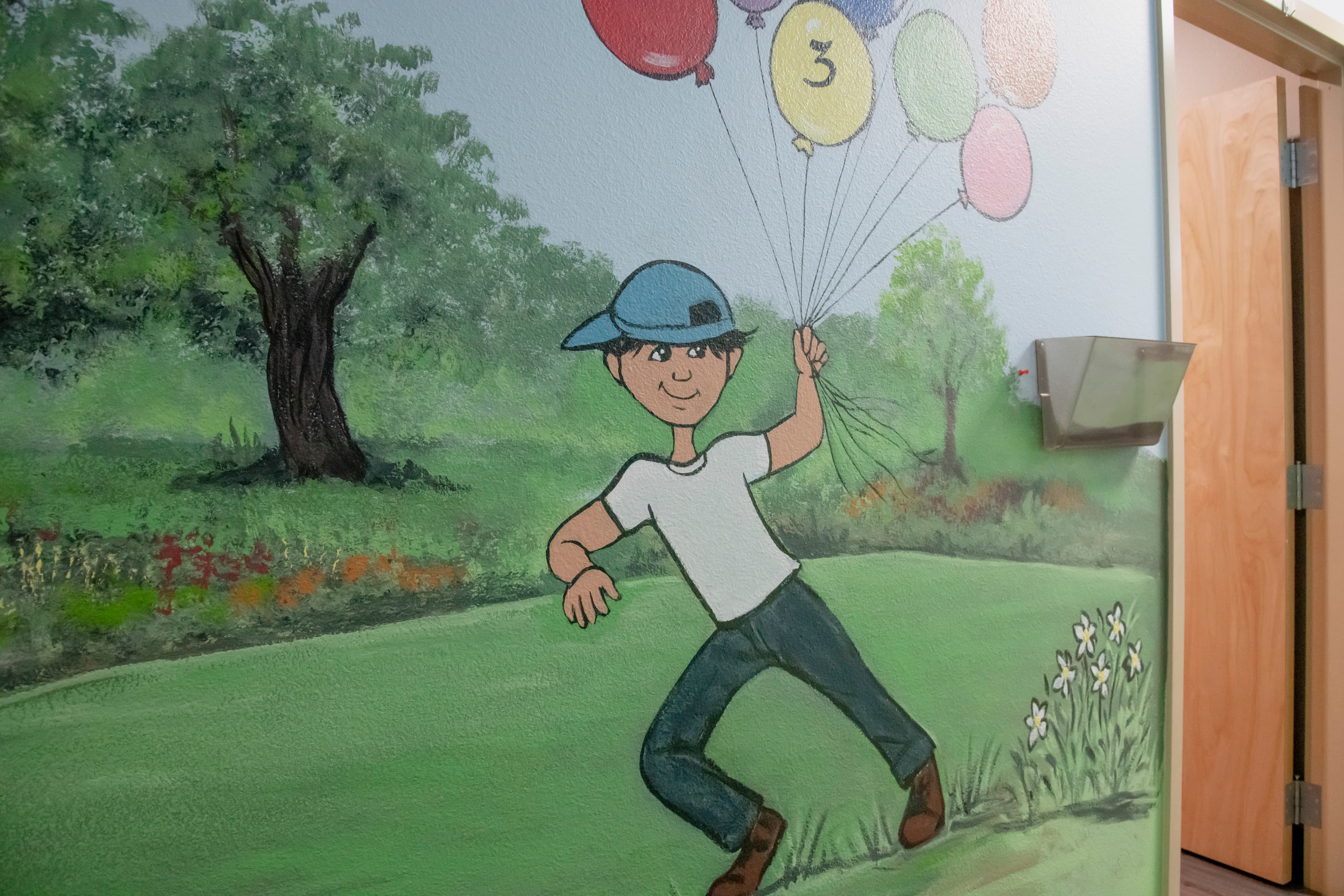 graphic image of a boy holding balloons