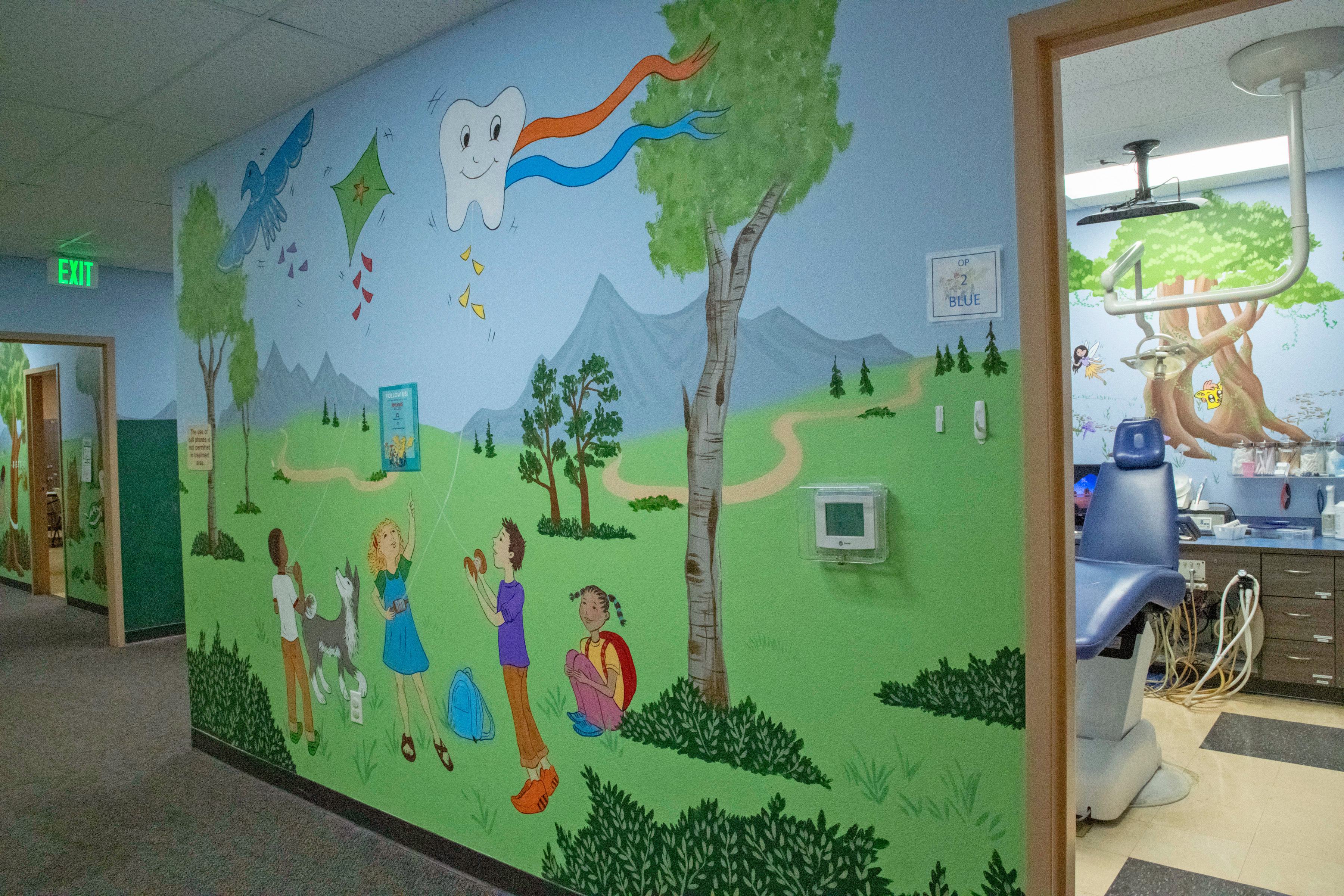 colorful wall graphics with children playing in a park